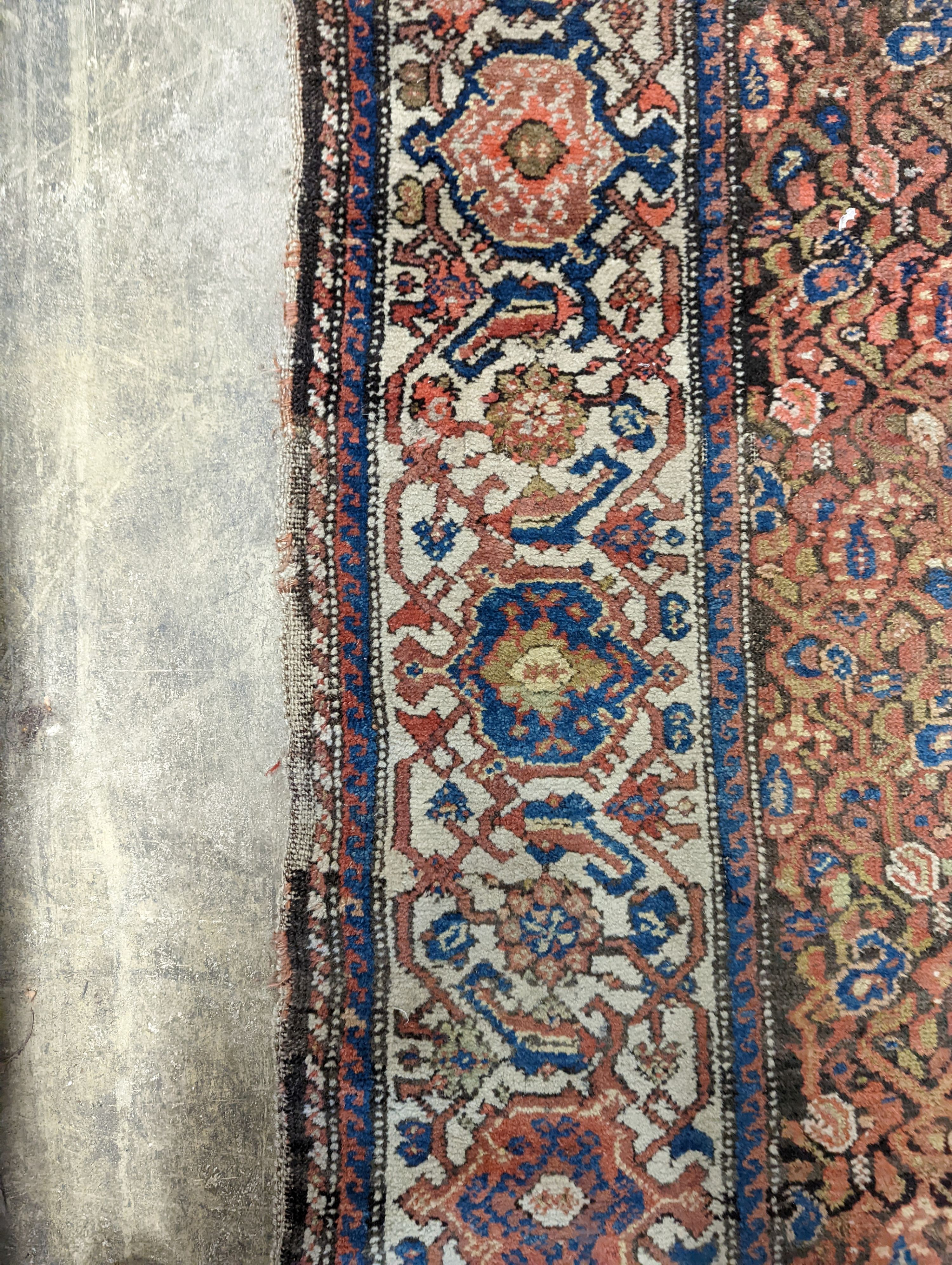 A Persian black ground runner, the central field including boteh motifs, 280 x 106cm, worn